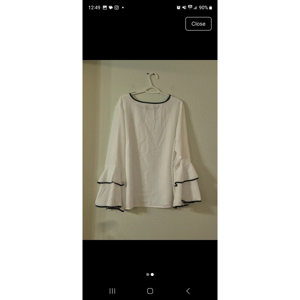 Womens White blouse with Navy trim and flared Ruffle sleeves.